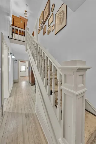 a view of entryway and hall with wooden floor