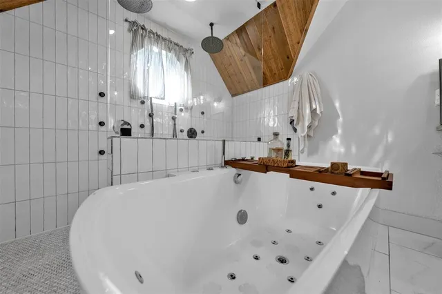 a large white tub sitting in a bathroom