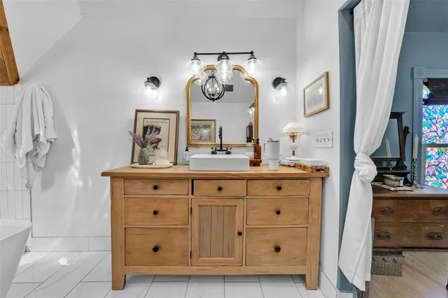 a bathroom with a double vanity sink and a mirror