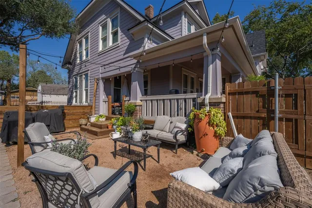 a view of a patio with couches table and chairs and potted plants
