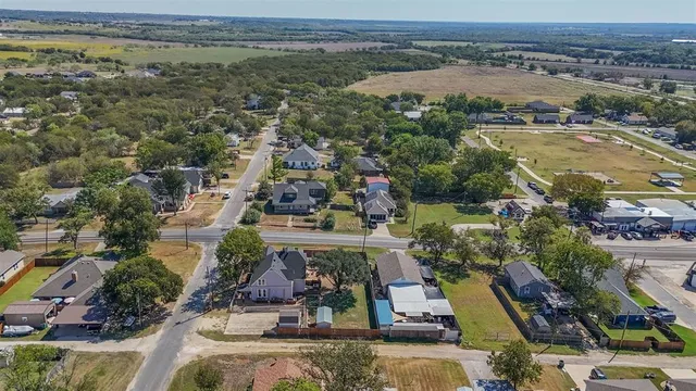 an aerial view of multiple houses with a yard