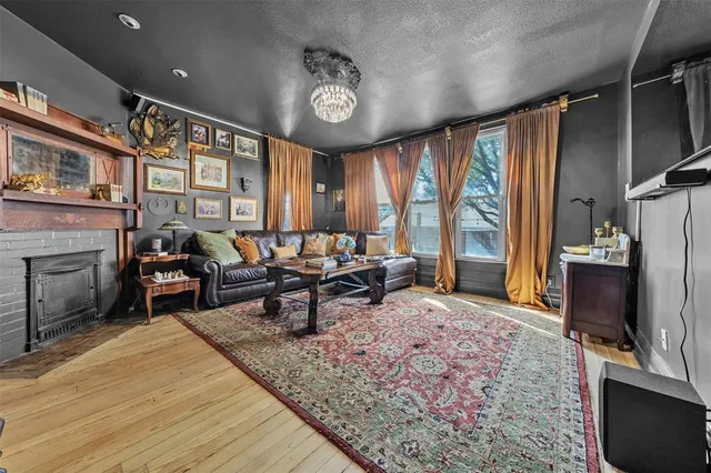 a living room with furniture a large window and a flat screen tv