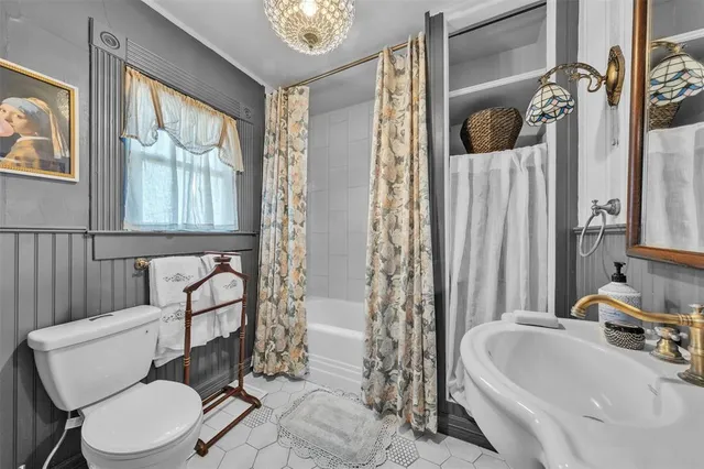 a bathroom with a toilet sink and tub