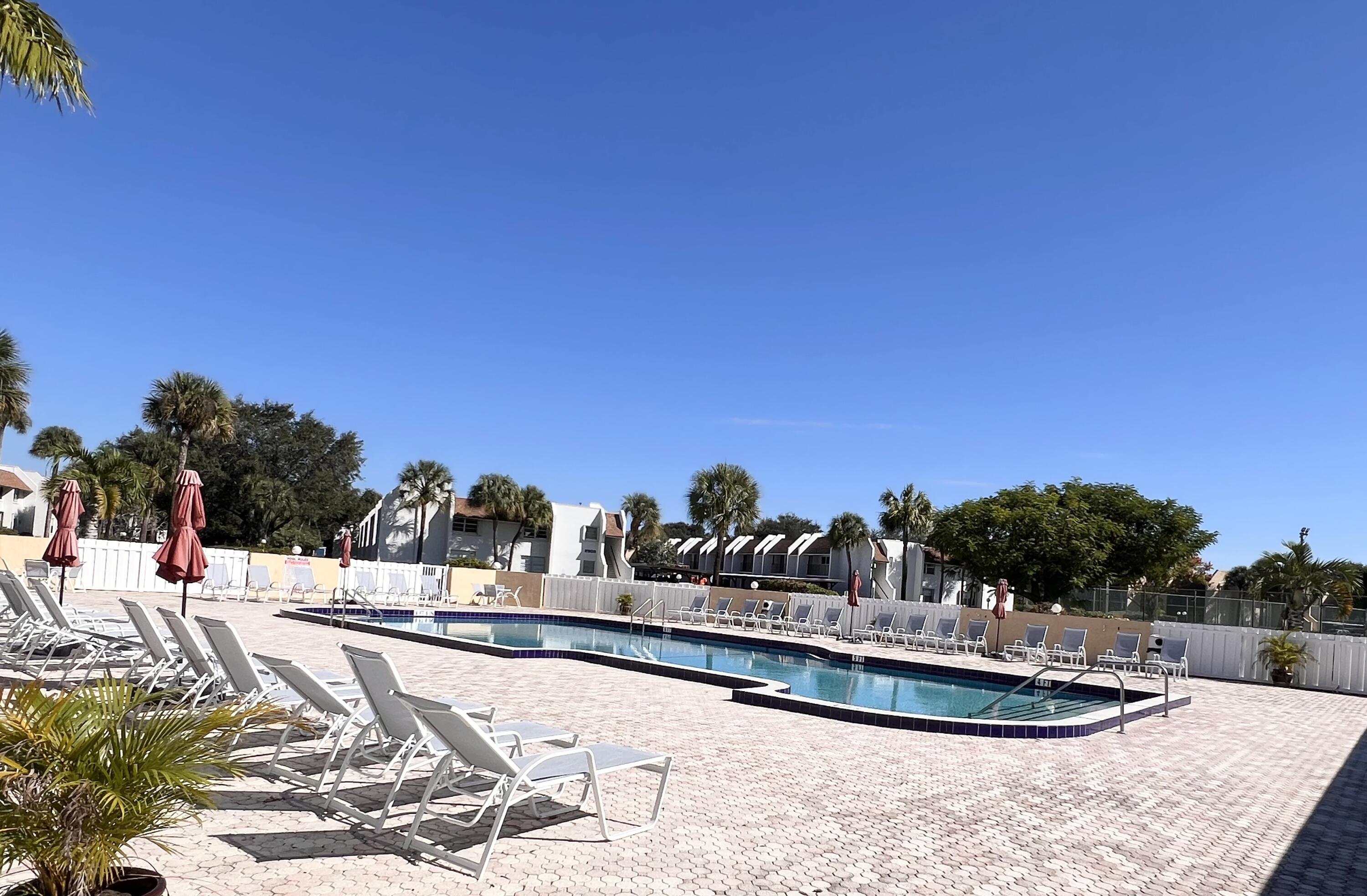 2865 Southwest 22nd Avenue, Unit 108 Delray Beach, FL 33445 - Photo 16 of 16 a outdoor space with lots of trees in the background