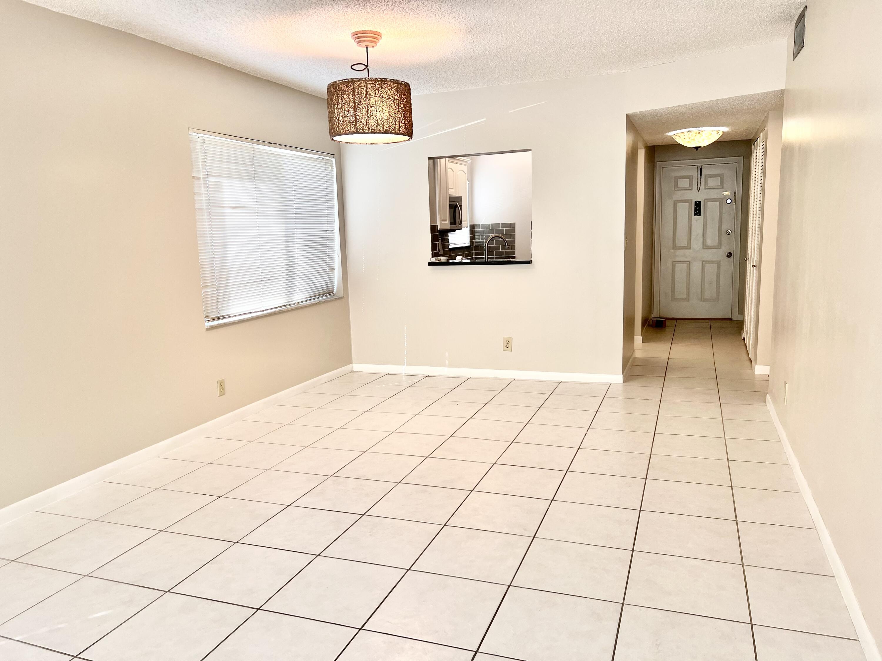 2865 Southwest 22nd Avenue, Unit 108 Delray Beach, FL 33445 - Photo 5 of 16 a view of a livingroom with wooden floor