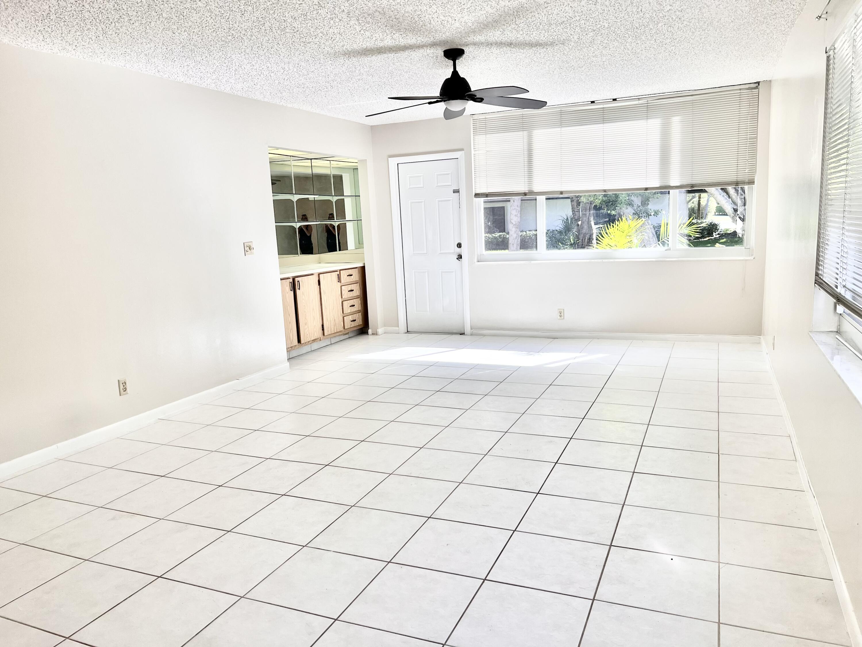 2865 Southwest 22nd Avenue, Unit 108 Delray Beach, FL 33445 - Photo 7 of 16 a view of a livingroom with white furniture
