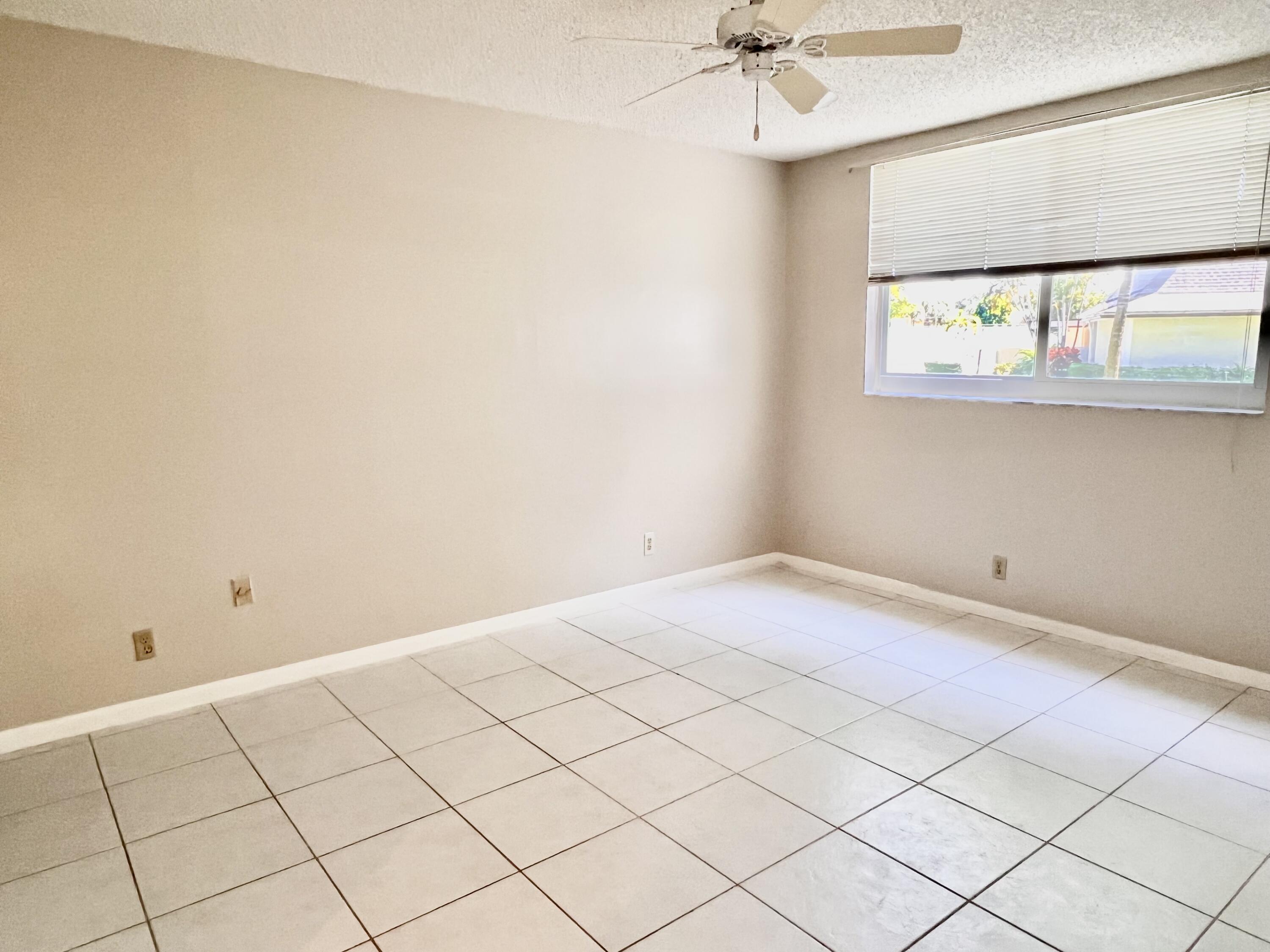 2865 Southwest 22nd Avenue, Unit 108 Delray Beach, FL 33445 - Photo 8 of 16 a view of an empty room and a window