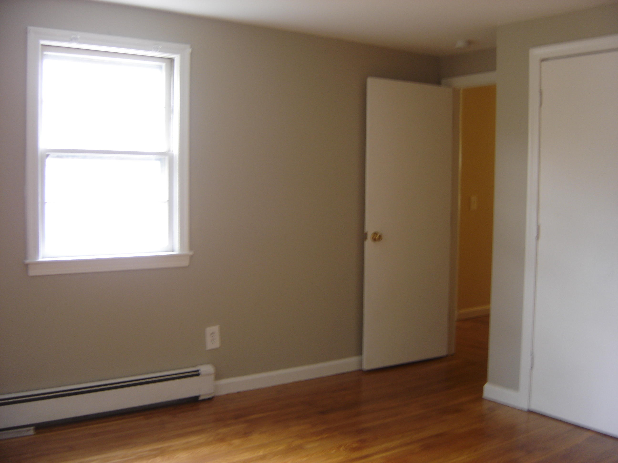 75 Quaker Road Hyannis, MA 02601 - Photo 15 of 28 a view of an empty room with wooden floor and a window
