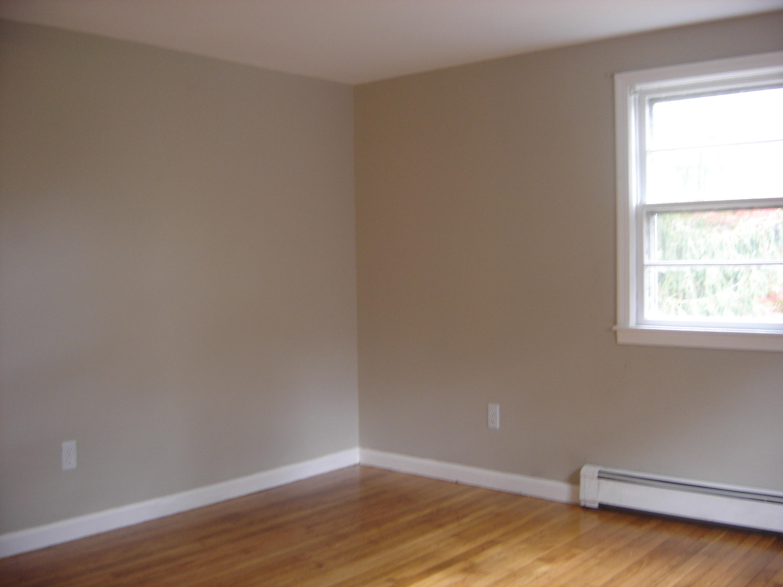 75 Quaker Road Hyannis, MA 02601 - Photo 16 of 28 a view of an empty room with wooden floor and a window