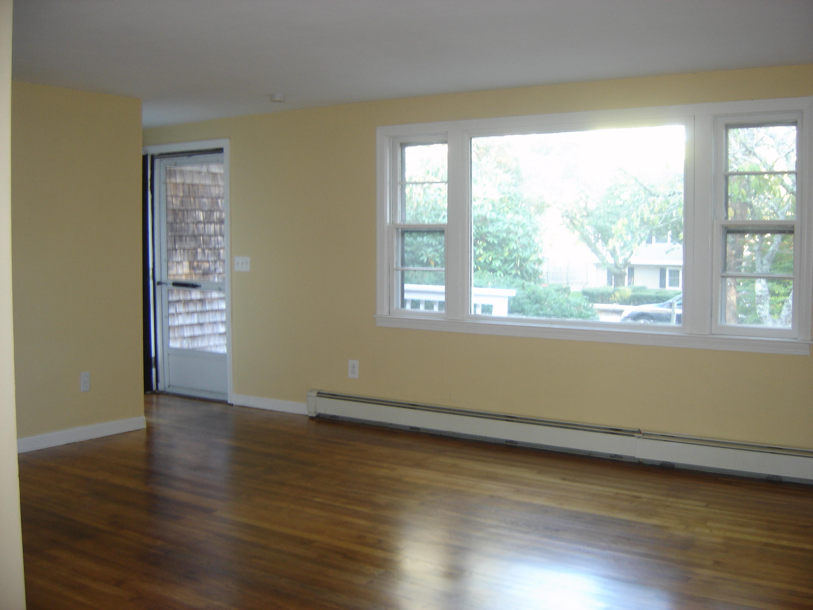 75 Quaker Road Hyannis, MA 02601 - Photo 3 of 28 a view of an empty room with wooden floor and a window