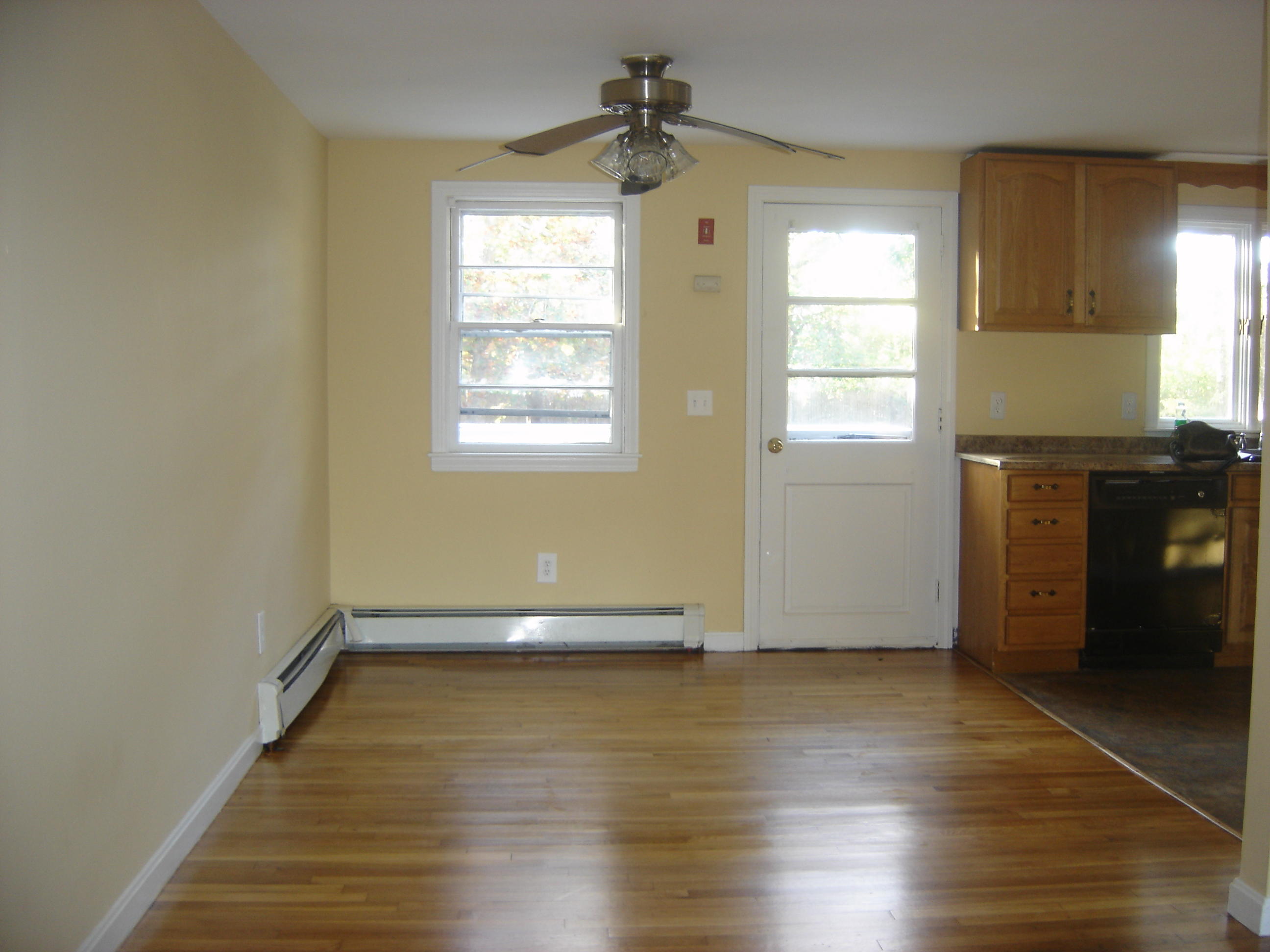 75 Quaker Road Hyannis, MA 02601 - Photo 6 of 28 an empty room with wooden floor and windows