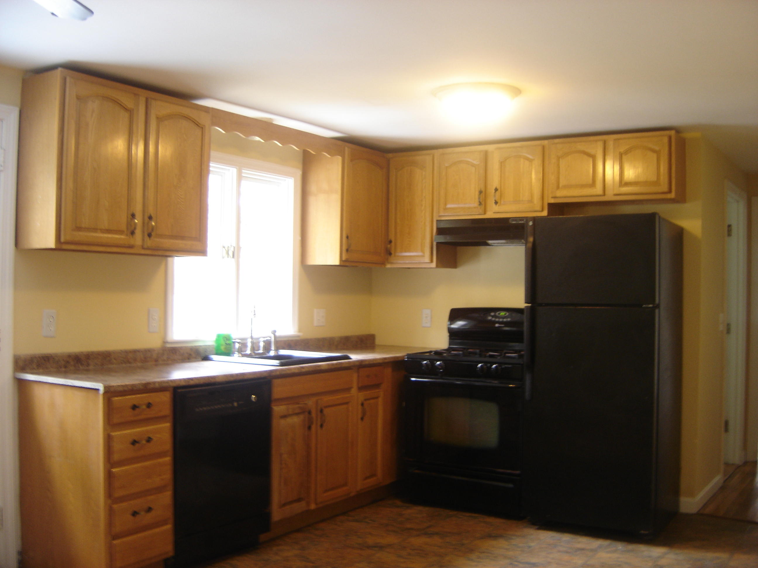 75 Quaker Road Hyannis, MA 02601 - Photo 9 of 28 a kitchen with a sink a refrigerator and cabinets