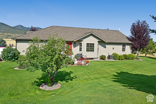 1500 Fish Creek Road Bancroft, ID 83217 - Photo 39 of 45 View of front of home featuring a patio, a front yard, and roof with shingles