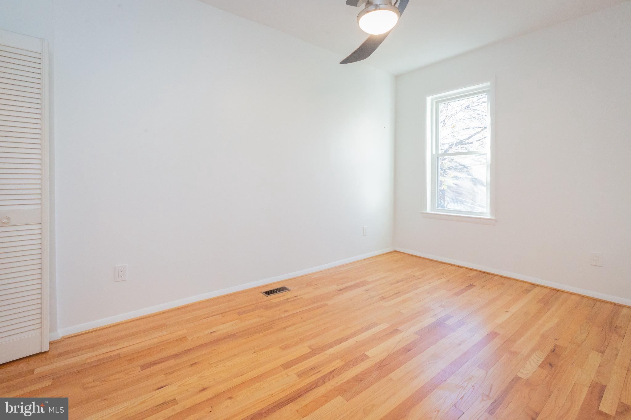 1814 15th Street Northwest, Unit A Washington, DC 20009 - Photo 11 of 15 an empty room with wooden floor and windows