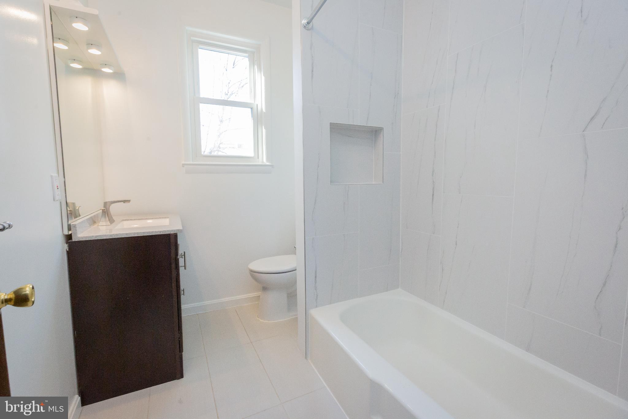 1814 15th Street Northwest, Unit A Washington, DC 20009 - Photo 14 of 15 a bathroom with a sink a toilet and bathtub