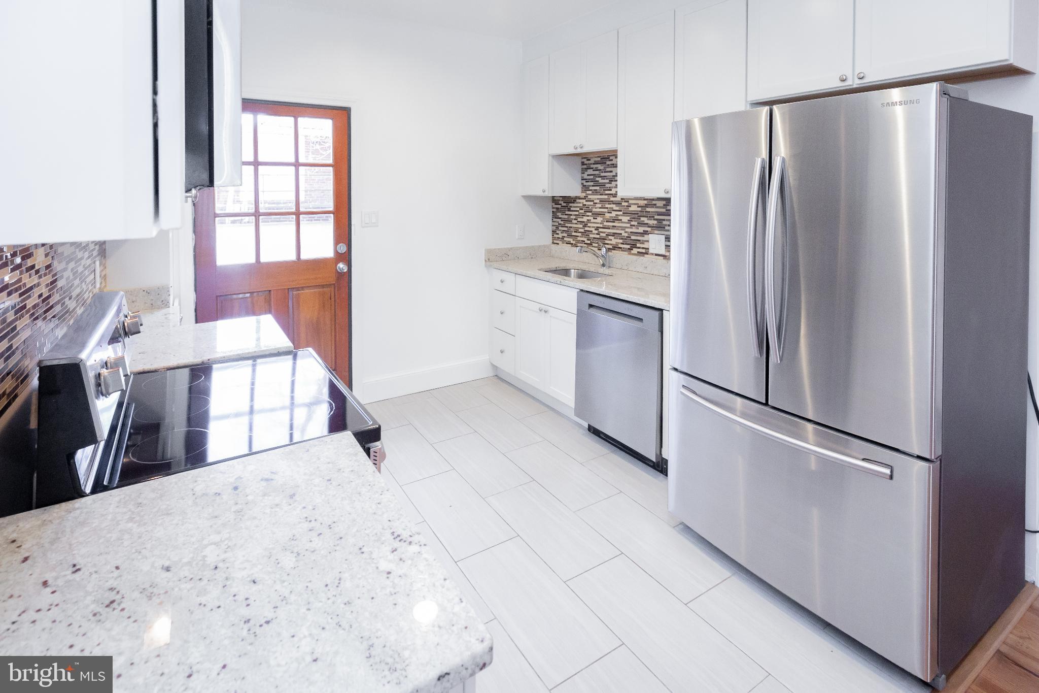 1814 15th Street Northwest, Unit A Washington, DC 20009 - Photo 2 of 15 a kitchen with stainless steel appliances a refrigerator sink and cabinets