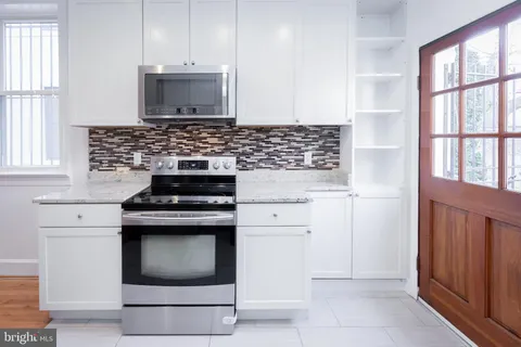 a kitchen with a stove and a microwave