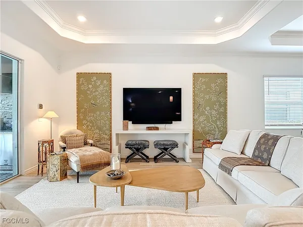 a living room with furniture a rug and a window