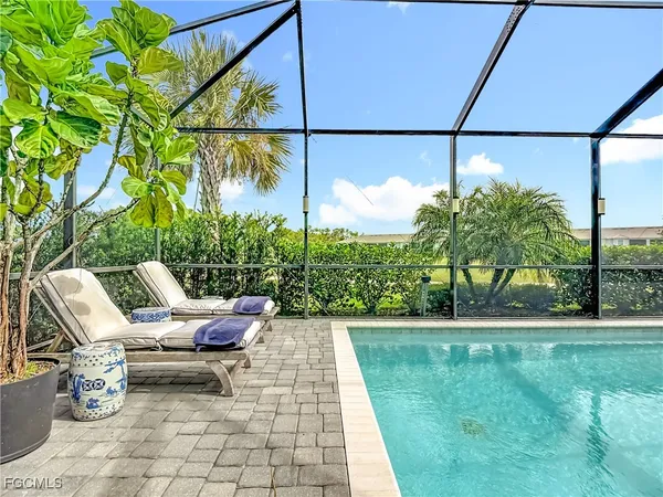 a bedroom with a bed and glass windows
