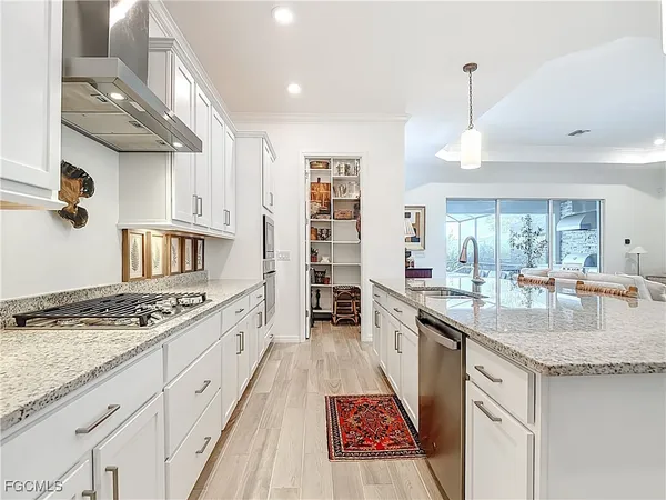 a living room with furniture kitchen view and a flat screen tv