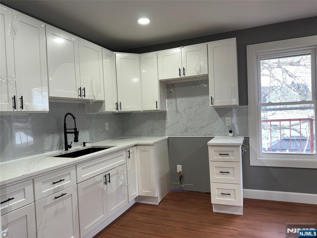 178 Berry Street Hackensack, NJ 07601 - Photo 12 of 22 a kitchen with granite countertop white cabinets and white appliances