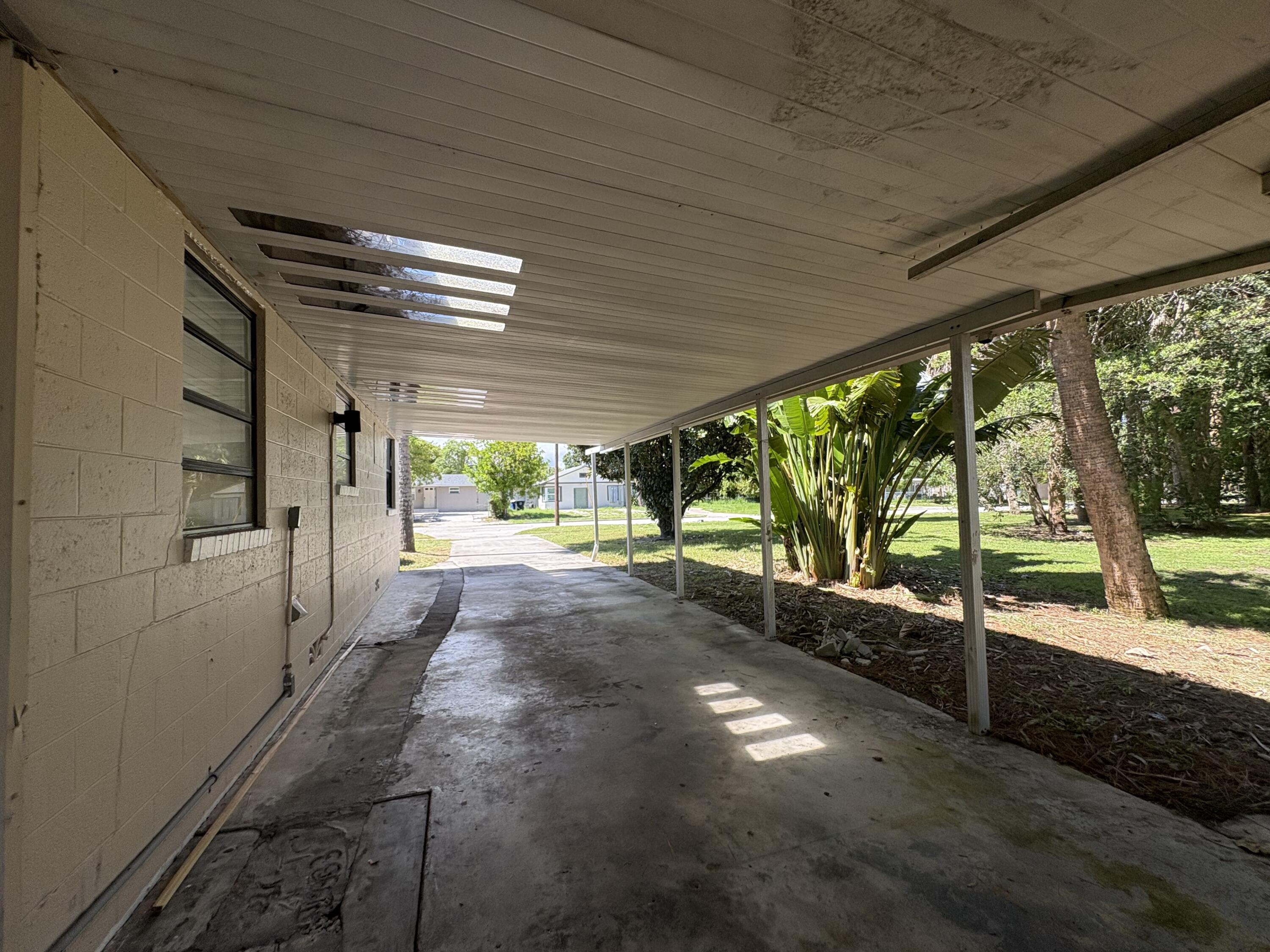 1010 Mayflower Road Fort Pierce, FL 34950 - Photo 14 of 27 a view of a porch with wooden floor and iron stairs