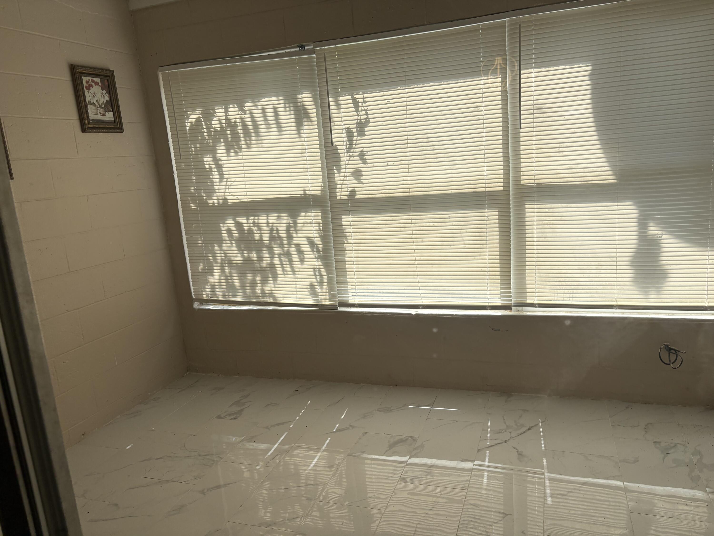 1010 Mayflower Road Fort Pierce, FL 34950 - Photo 3 of 27 a view of an empty room with a window