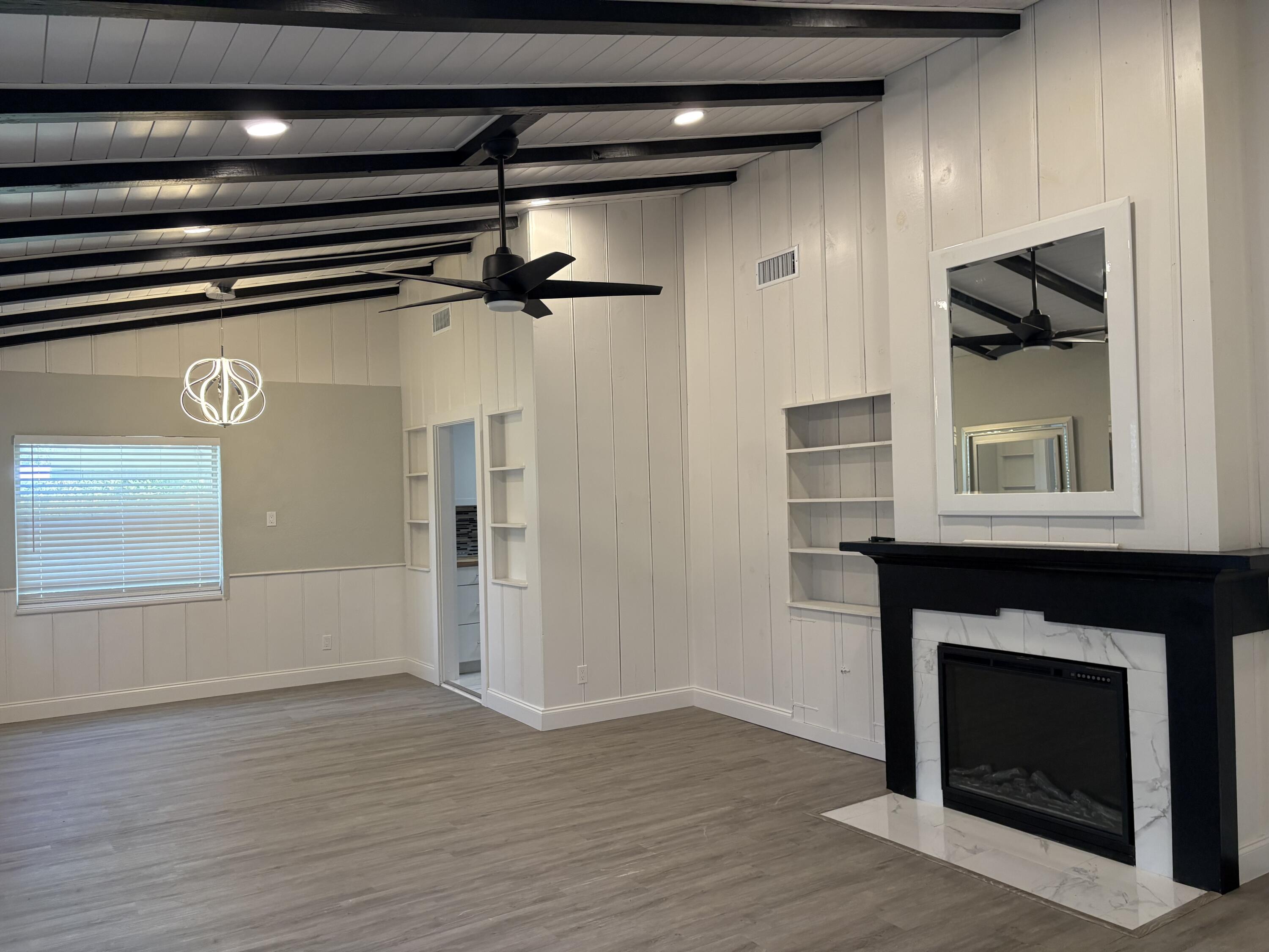 1010 Mayflower Road Fort Pierce, FL 34950 - Photo 5 of 27 a view of an empty room with a fireplace and a window