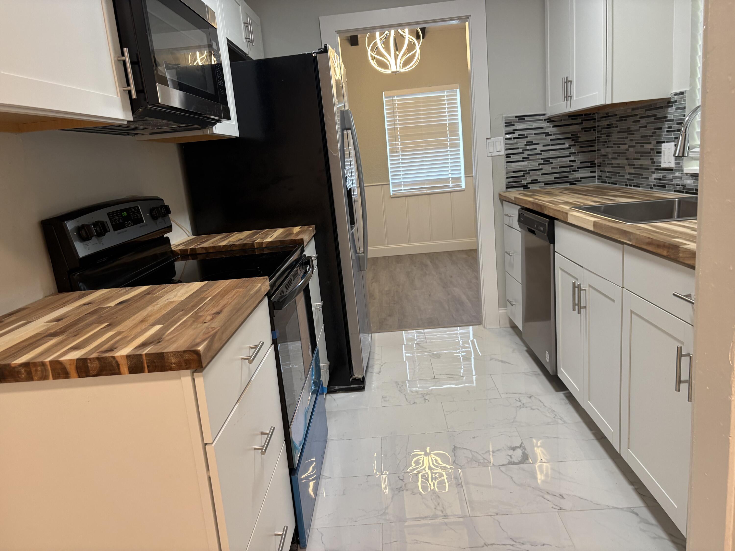 1010 Mayflower Road Fort Pierce, FL 34950 - Photo 8 of 27 a utility room with wooden floor washer and dryer