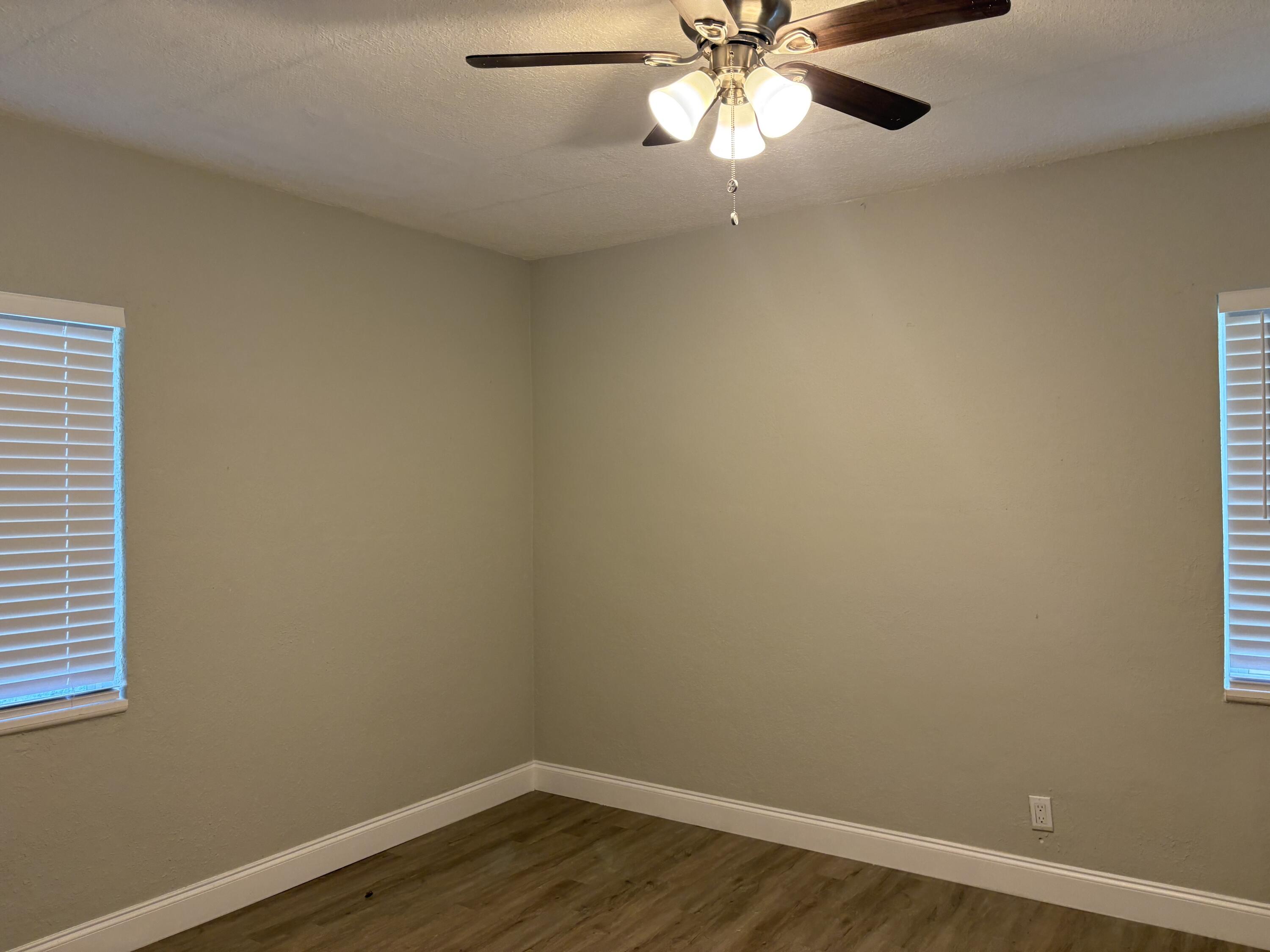 1010 Mayflower Road Fort Pierce, FL 34950 - Photo 9 of 27 an empty room with a window and a fan