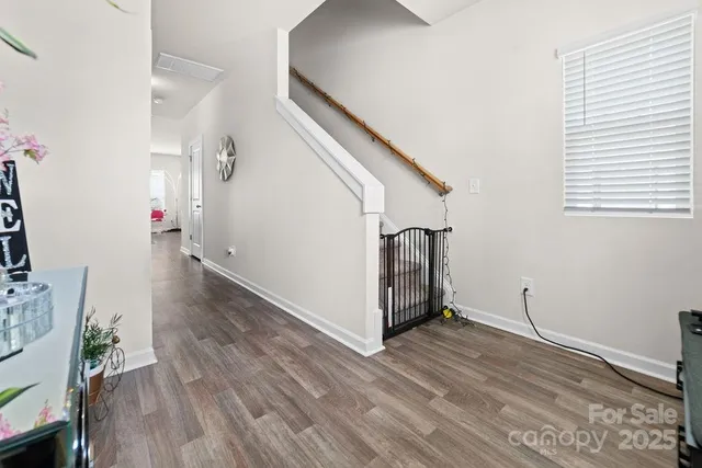 a view of entryway and hall with wooden floor