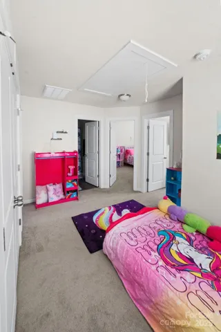 a bedroom with a bed and a lamp