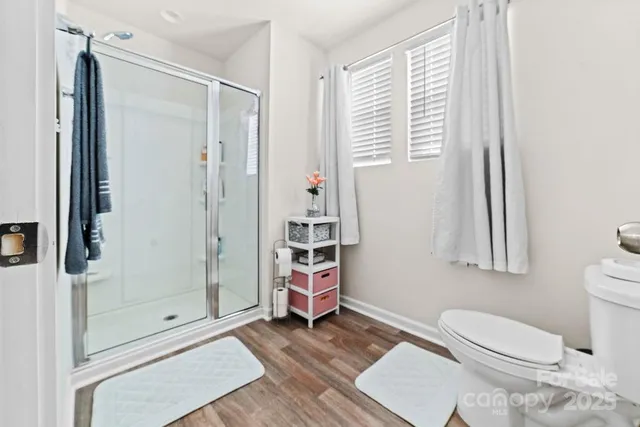 a bathroom with a toilet and a shower