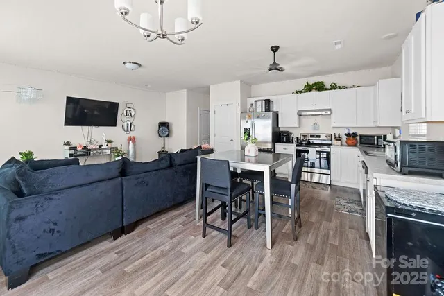 a view of a dining room with furniture and wooden floor