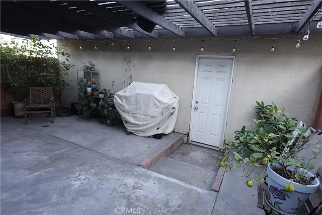 a view of a porch with furniture and a yard