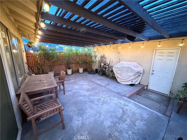 a kitchen with stainless steel appliances granite countertop a refrigerator a sink dishwasher and a stove with wooden floor