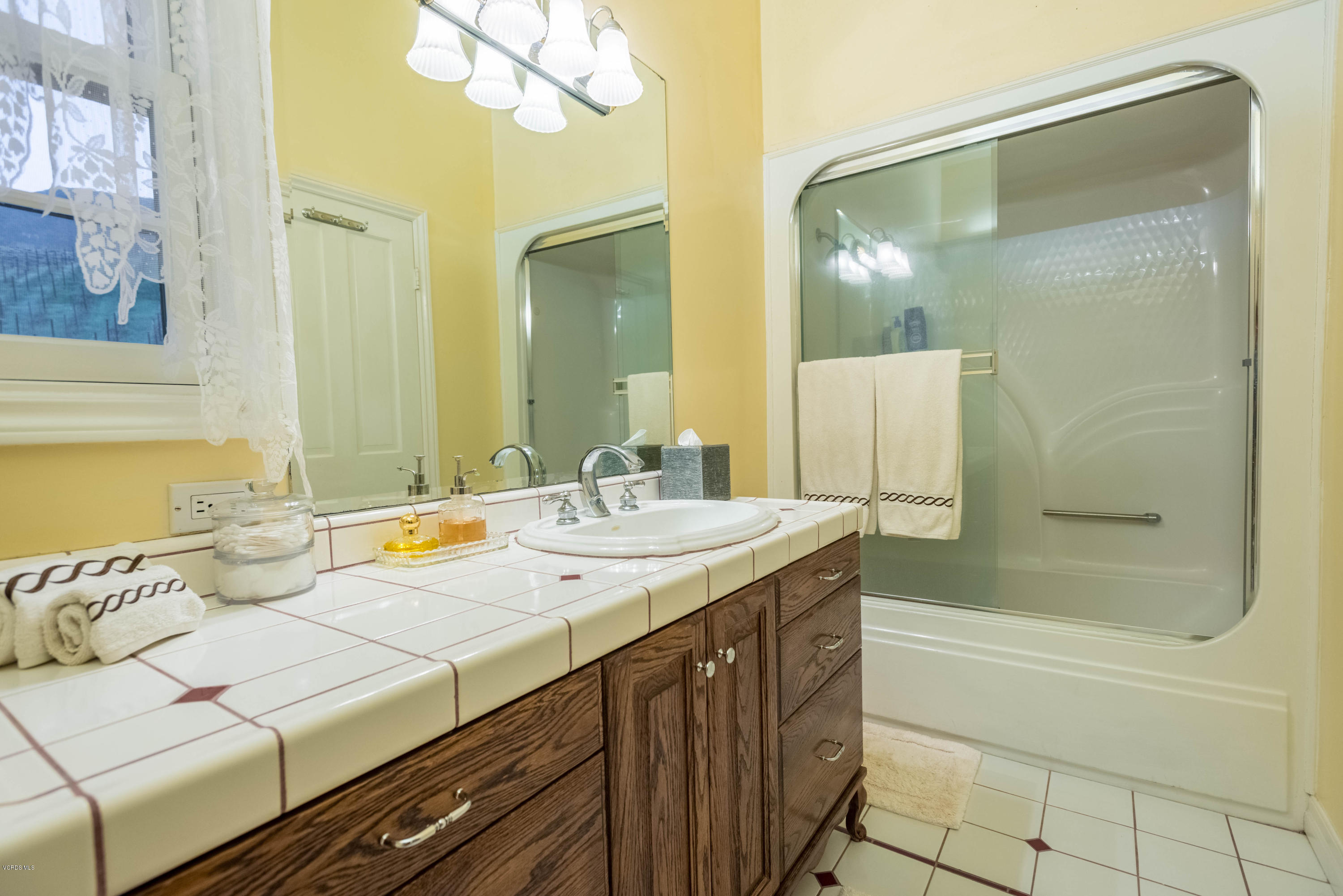 1735 Pancho Road Camarillo, CA 93012 - Photo 30 of 70 a bathroom with a granite countertop sink and a mirror