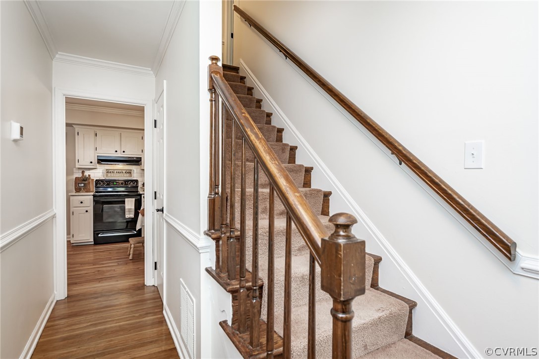 4901 Court Ridge Terrace Midlothian, VA 23112 - Photo 6 of 35 a view of a hallway with wooden floor and staircase
