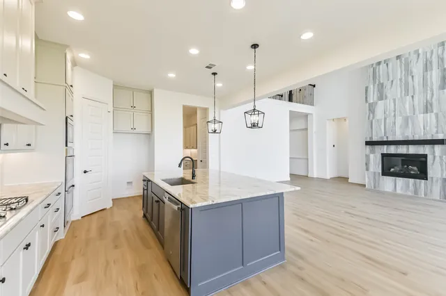 a spacious bathroom with a double vanity sink a large mirror and shower