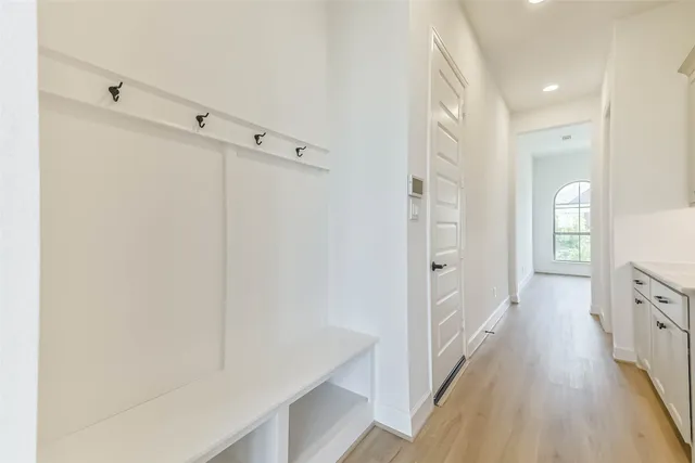 a view of a hallway with wooden floor