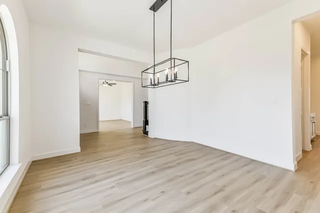 a view of a room with wooden floor and white walls