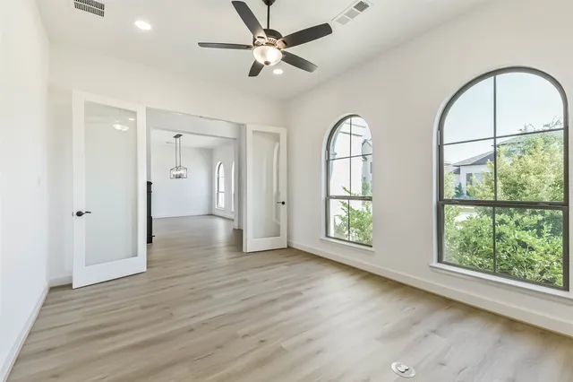 a view of an empty room with window wooden floor and a window