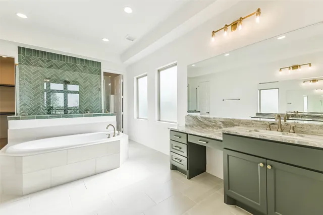 a bathroom with a granite countertop sink mirror and bathtub