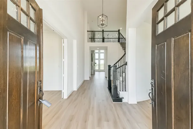 a view of a hallway with wooden floor and entryway