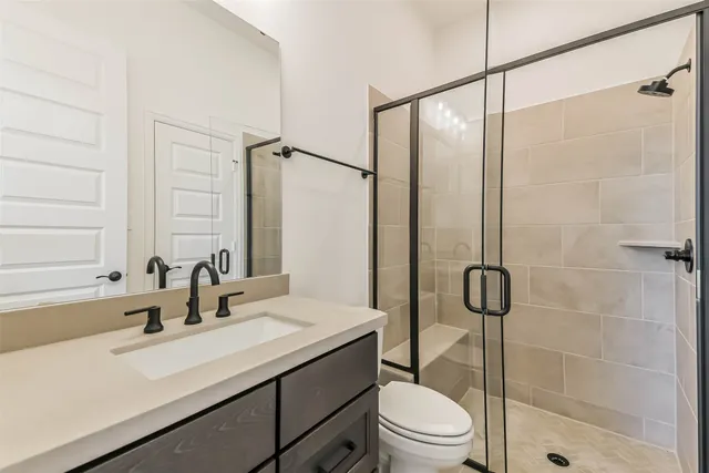 a bathroom with a sink toilet and shower