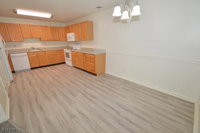 a room with wooden floor and electronic appliances