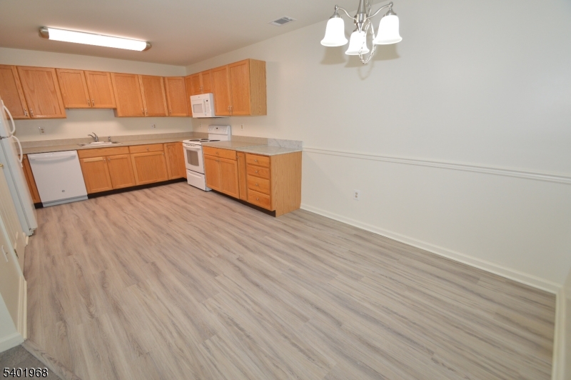 1 Jenny Lind Street, Unit 11 Netcong, NJ 07857 - Photo 21 of 24 a kitchen with stainless steel appliances granite countertop a dishwasher a stove and a wooden floors