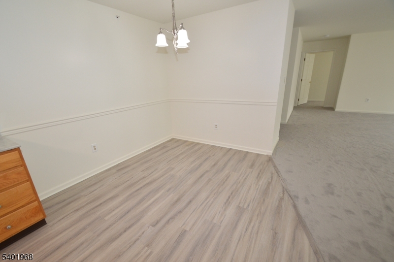 1 Jenny Lind Street, Unit 11 Netcong, NJ 07857 - Photo 24 of 24 an empty room with wooden floor and chandelier