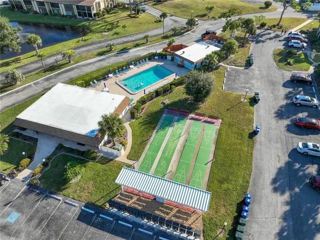 an aerial view of a house with a garden and outdoor seating