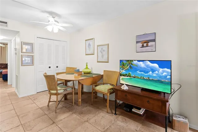 a view of a dining room with furniture and a flat screen tv